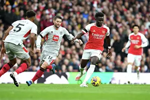 Arsenal's Bukayo Saka Fends Off Sheffield United's Oliver Norwood: Premier League Showdown at Emirates Stadium (2023-24)