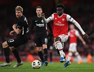 Arsenal's Bukayo Saka Goes Head-to-Head with Eintracht Frankfurt's Martin Hinteregger in Europa League Showdown