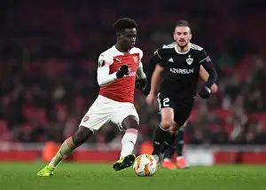 Arsenal V Qarabag 2018-19 Prints: Arsenal's Bukayo Saka Goes Head-to-Head with Qarabag's Gara Gareyev in Europa League Battle