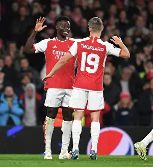 Arsenal V Sevilla 2023-24 Prints: Arsenal's Bukayo Saka and Leandro Trossard Celebrate Goals Against Sevilla in 2023-24 UEFA Champions League