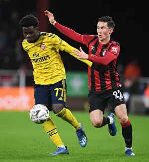 AFC Bournemouth V Arsenal - FA Cup 4th Rd 2020 Prints: Arsenal's Bukayo Saka Outmaneuvers Bournemouth's Harry Wilson in FA Cup Fourth Round Clash