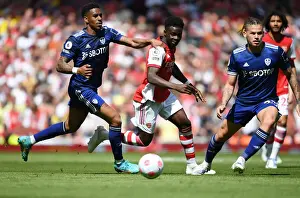Arsenal's Bukayo Saka Outmaneuvers Leeds Junior Firpo in Premier League Clash