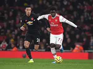 Arsenal's Bukayo Saka Outmaneuvers Manchester United's Mason Greenwood in Premier League Clash