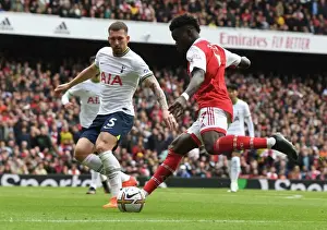 Arsenal's Bukayo Saka Outmaneuvers Tottenham's Pierre-Emile Hojbjerg in the 2022-23 Premier League Clash