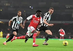 Arsenal V Newcastle United 2022-23 Prints: Arsenal's Bukayo Saka Outsmarts Newcastle's Dan Burn: A Premier League Tactical Showdown