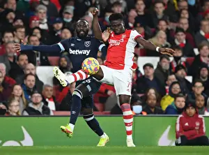 Arsenal V West Ham United 2021-22 Prints: Arsenal's Bukayo Saka Outwits Arthur Masuaku: A Premier League Battle at Emirates Stadium