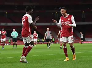 Arsenal's Bukayo Saka and Pierre-Emerick Aubameyang Celebrate Goals Amidst Empty Emirates Stadium (Arsenal v Newcastle United, Premier League 2021)