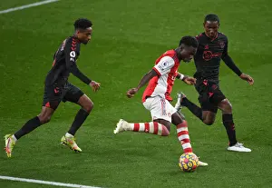 Arsenal V Southampton 2021-22 Prints: Arsenal's Bukayo Saka Tackles Southampton Duo in Premier League Clash