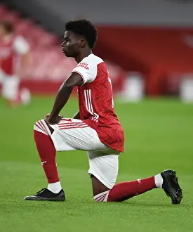 Arsenal's Bukayo Saka Takes a Knee during Emirates Stadium's Empty Ranks: Arsenal v Leicester City, 2020-21 Premier League