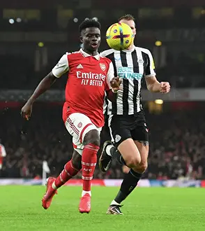 Arsenal V Newcastle United 2022-23 Prints: Arsenal's Bukayo Saka Takes on Newcastle's Dan Burn in Premier League Clash