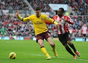 Images Dated 9th February 2013: Arsenal's Carl Jenkinson Fends Off Sunderland's Danny Rose
