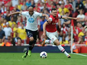 Spurs Prints: Arsenal's Carl Jenkinson Outmaneuvers Tottenham's Sandro in Premier League Clash