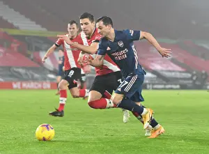 Southampton V Arsenal 2020-21 Prints: Arsenal's Cedric Breaks Past Southampton's Bednarek in Empty St