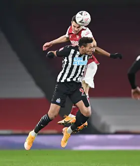 Arsenal's Cedric Soars Above Joelinton in FA Cup Clash: Arsenal vs. Newcastle United (2020-21)