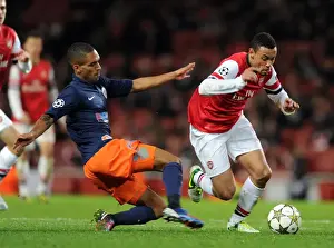 Arsenal V Montpellier 2012-13 Prints: Arsenal's Coquelin Clashes with Montpellier's Marveaux in Champions League Showdown