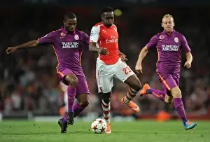 Arsenal V Galatasaray 2014/15 Champions League Prints: Arsenal's Danny Welbeck Clashes with Galatasaray's Aurelien Chedjou and Semih Kaya in Champions League Showdown