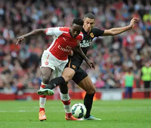 Arsenal V Hull City 2014-15 Prints: Arsenal's Danny Welbeck Faces Off Against Hull's Jake Livermore in Intense Premier League Clash