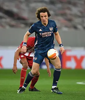 Olympiacos V Arsenal 2020-21 Prints: Arsenal's David Luiz Battles Through Olympiacos in Empty Europa League Stadium