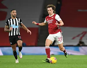 Arsenal's David Luiz Outmaneuvers Newcastle's Callum Wilson in Empty Emirates Stadium