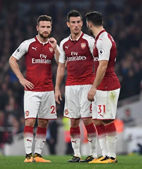 Arsenal v West Bromwich Albion 2017-18 Collection: Arsenal's Defensive Trio: Mustafi, Koscielny, and Kolasinac in Action