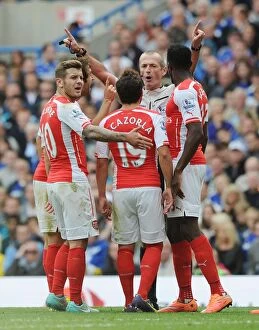 Chelsea v Arsenal 2014-15 Collection: Arsenal's Dispute with Referee: Wilshere, Cazorla, and Welbeck at Chelsea's Stamford Bridge