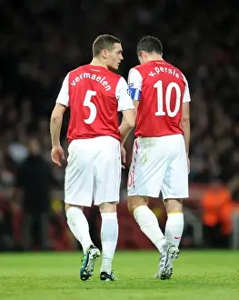 Arsenal's Double Strike: Van Persie and Vermaelen Lead 2:0 Over Borussia Dortmund in UEFA Champions League