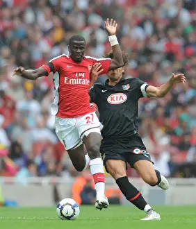 Arsenal V Athletico Madrid 2009-10 Prints: Arsenal's Eboue vs. Athletico's Dominguez: A Clash at the Emirates Cup, 2009