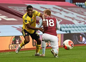 Arsenal's Eddie Nketiah Clashes with Aston Villa's Matt Targett in Premier League Showdown