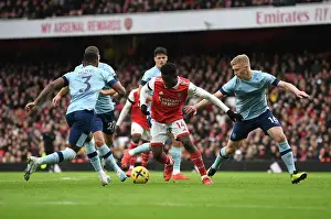 Arsenal's Eddie Nketiah Clashes with Brentford's Ben Mee and Rico Henry in Premier League Showdown