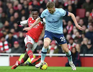Arsenal's Eddie Nketiah Clashes with Brentford's Kristoffer Ajer in Premier League Showdown at Emirates Stadium