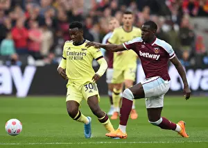 West Ham United V Arsenal 2021-22 Prints: Arsenal's Eddie Nketiah Clashes with West Ham's Kurt Zouma in Premier League Showdown