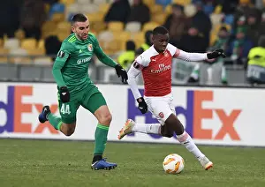 FC Vorskla Poltava V Arsenal 2018-19 Prints: Arsenal's Eddie Nketiah Faces Off Against Ardin Dallku in Europa League Clash