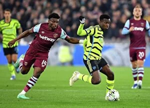 West Ham United v Arsenal - Carabao Cup 2023-24 Collection: Arsenal's Eddie Nketiah Faces Off Against West Ham's Mohammed Kudus in Carabao Cup Clash