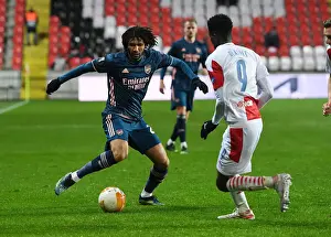 Arsenal's Elneny Clashes with Slavia Praha's Olayinka in UEFA Europa League Quarterfinal: Prague Showdown Amidst Empty Stands