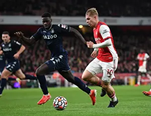 Arsenal's Emile Smith Rowe Clashes with Aston Villa's Axel Tuanzebe in Premier League Showdown