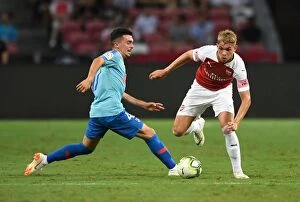 Arsenal v Atletico Madrid 2018-19 Collection: Arsenal's Emile Smith Rowe Clashes with Atletico Madrid's Joaquin Munoz in International Champions