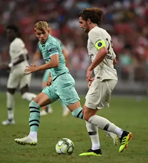 Arsenal's Emile Smith Rowe Clashes with Paris Saint-Germain's Adrien Rabiot in Pre-Season Friendly