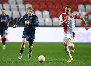 Arsenal's Emile Smith Rowe Clashes with Slavia Praha's Lukas Provod in UEFA Europa League Quarterfinal: Prague Showdown Amidst Empty Stands