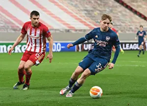 Olympiacos V Arsenal 2020-21 Prints: Arsenal's Emile Smith Rowe Faces Off Against Olympiacos Sokratis in Empty Europa League Stadium
