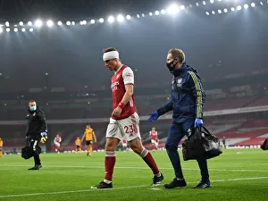 Arsenal's Empty Emirates: David Luiz Receives Treatment Alone Amidst Quiet Stadium Crowds (2020-21 Premier League: Arsenal vs. Wolverhampton Wanderers)
