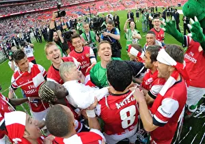 Arsenal's FA Cup Triumph: Arsene Wenger and the Jubilant Squad Celebrate