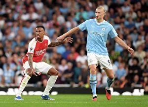 Arsenal v Manchester City 2023-24 Collection: Arsenal's Gabriel Holds Off Manchester City's Haaland in Intense Premier League Clash (2023-24)