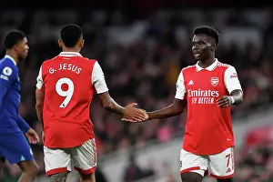 Arsenal's Gabriel Jesus and Bukayo Saka Share a Moment Amidst the Intensity of the Arsenal v Chelsea Rivalry (2022-23)