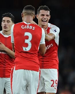 Images Dated 24th September 2016: Arsenal's Gibbs and Xhaka: A Post-Match Moment of Relief at Emirates Stadium (Arsenal v Chelsea)