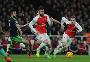 Arsenal's Giroud and Ramsey Outmaneuver Swansea's Amat during Intense Premier League Showdown