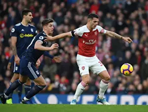 Arsenal's Granit Xhaka Fends Off Fulham's Tom Cairney in Premier League Clash