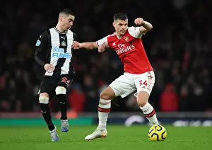 Arsenal V Newcastle United 2019-20 Prints: Arsenal's Granit Xhaka Holds Off Newcastle's Miguel Almiron During Premier League Clash