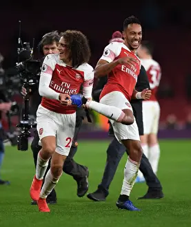 Arsenal's Guendouzi and Aubameyang: Celebrating a Hard-Fought Victory Over Tottenham