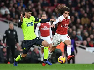 Arsenal V Huddersfield Town - 2018-19 Prints: Arsenal's Guendouzi Clashes with Schindler in Premier League Showdown