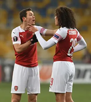 FC Vorskla Poltava V Arsenal 2018-19 Prints: Arsenal's Guendouzi and Lichtsteiner in Action during Europa League Match against Vorskla Poltava